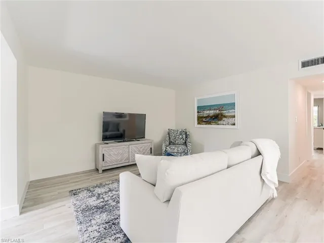 Living room with light wood finished floors and baseboards