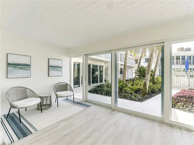 Unfurnished sunroom with wood finished floors and wood ceiling