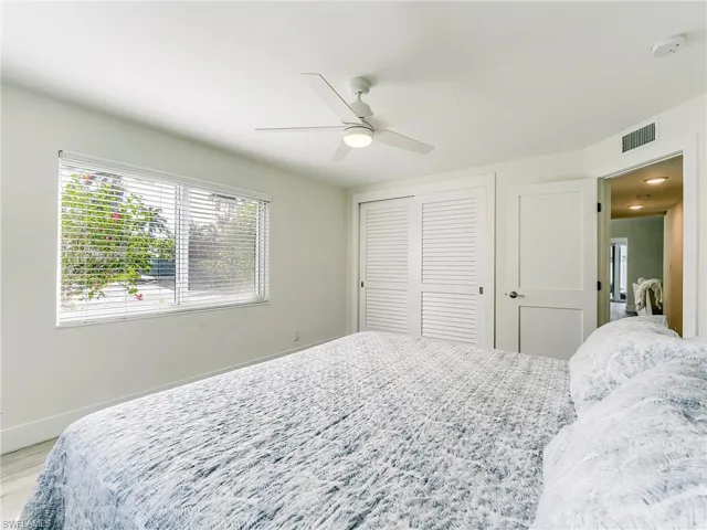 Bedroom featuring a ceiling fan, a closet, and wood finished floors