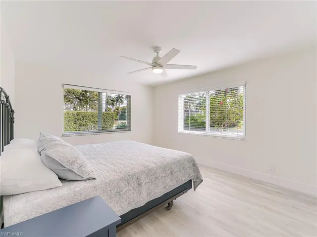 Bedroom with light wood-type flooring and a ceiling fan