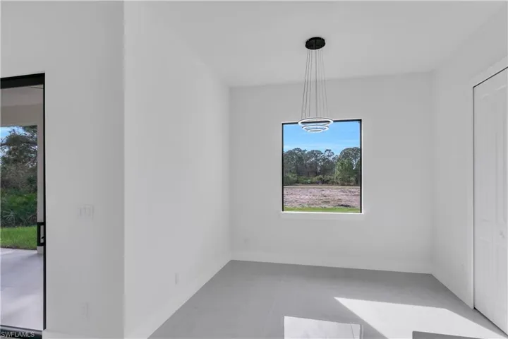 Unfurnished dining area with baseboards