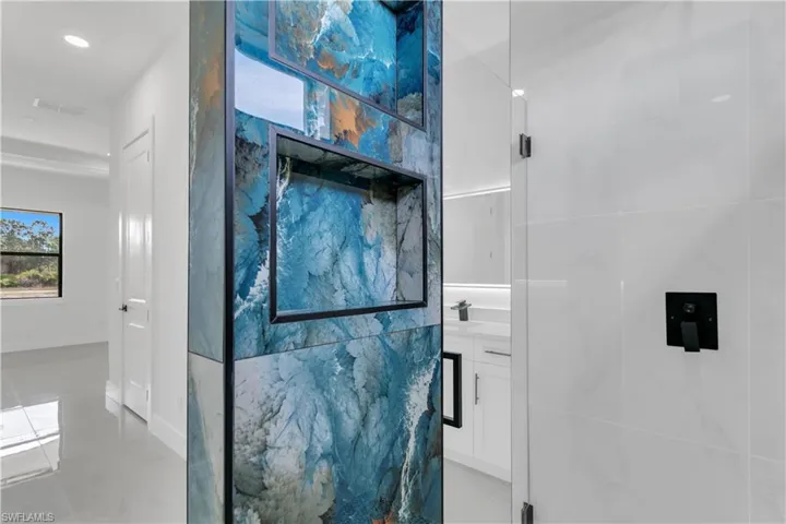 Bathroom featuring tile patterned flooring, vanity, and visible vents