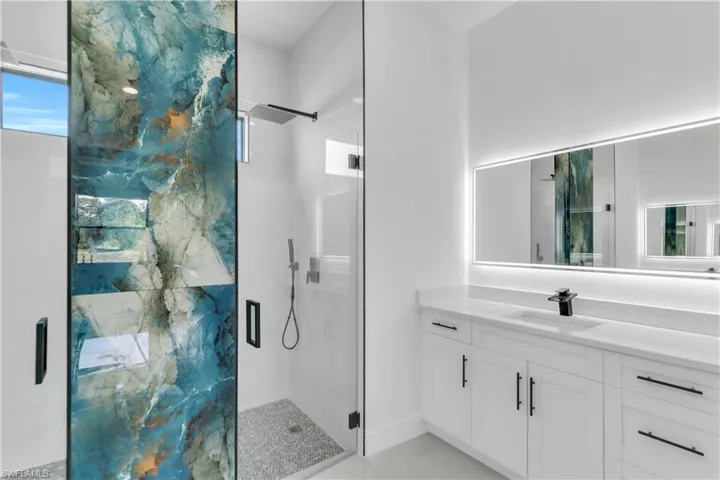 Bathroom featuring a stall shower and vanity