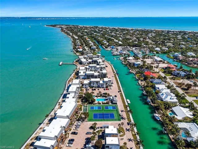 Aerial view of property and surrounding area with a nearby body of water