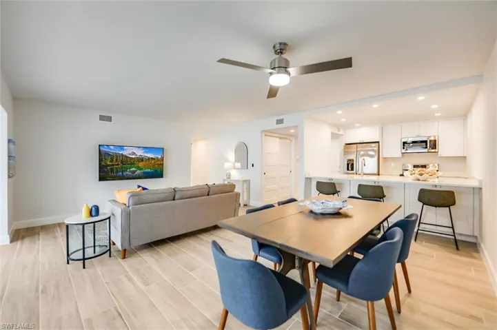Dining room featuring light wood-style floors, a ceiling fan, and recessed lighting