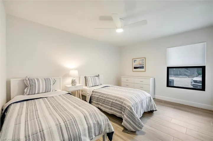 Bedroom with light wood-type flooring and a ceiling fan