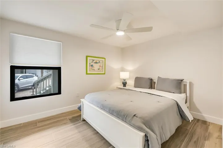 Bedroom with wood finished floors and a ceiling fan