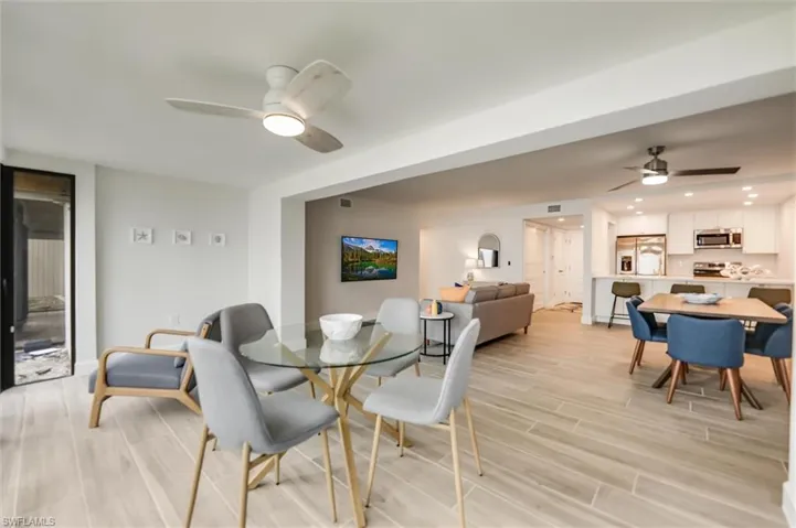 Dining room with ceiling fan, light wood-style floors, and recessed lighting