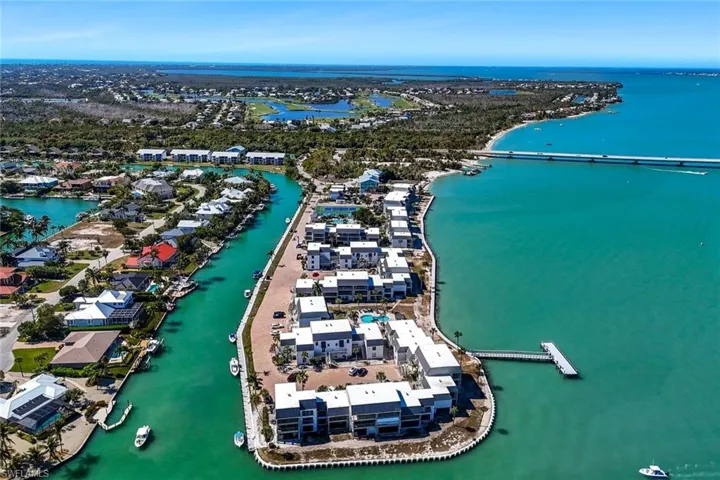 Aerial view of property and surrounding area featuring a nearby body of water
