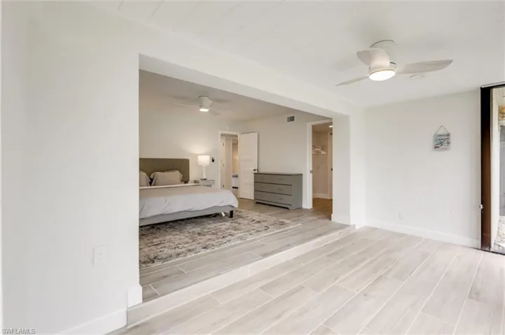Bedroom with light wood finished floors and a ceiling fan