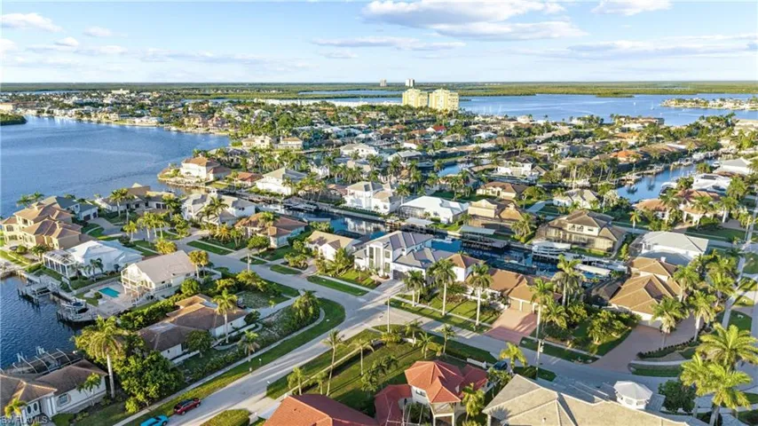 Aerial view of residential area featuring a large body of water