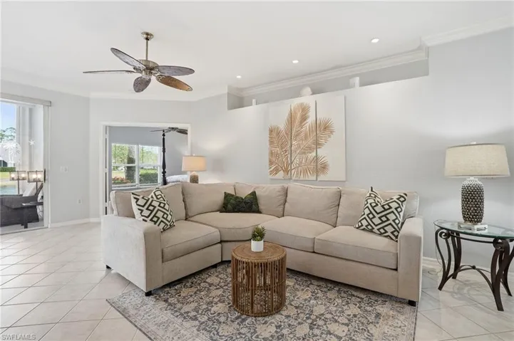 Living area with ornamental molding, light tile patterned flooring, a ceiling fan, and recessed lighting