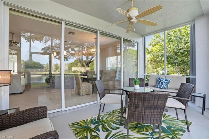 Sunroom / solarium with a ceiling fan and an outdoor living / dining area