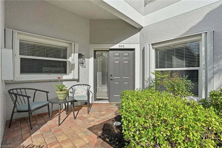 Entrance to property with stucco siding