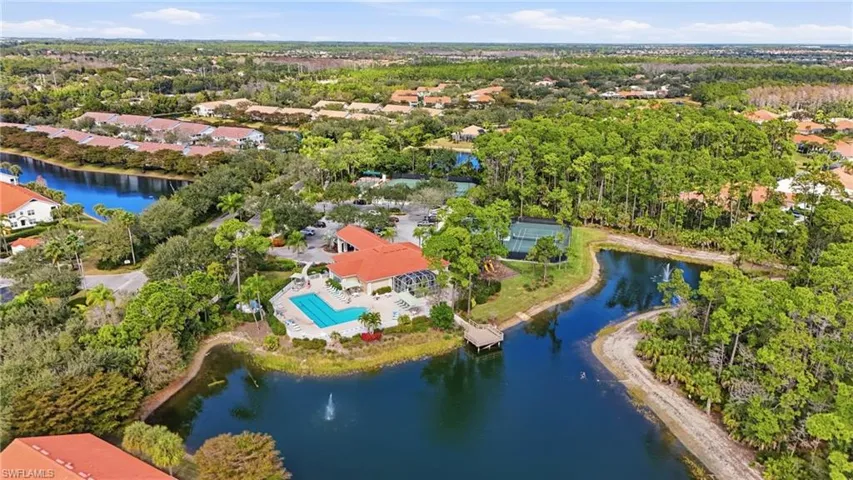 Aerial view of property and surrounding area with a nearby body of water