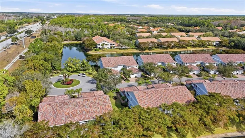 Aerial overview of property's location featuring a nearby body of water and nearby suburban area