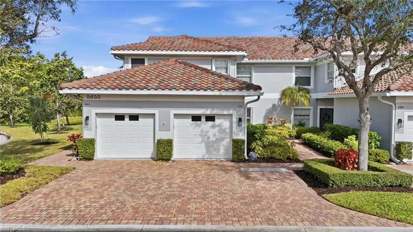 Mediterranean / spanish-style house with stucco siding, decorative driveway, a garage, and a tiled roof