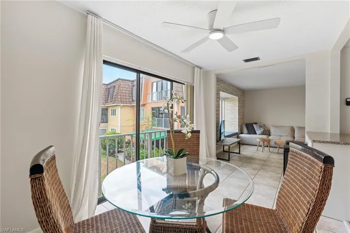 Dining room with a ceiling fan and light tile patterned floors