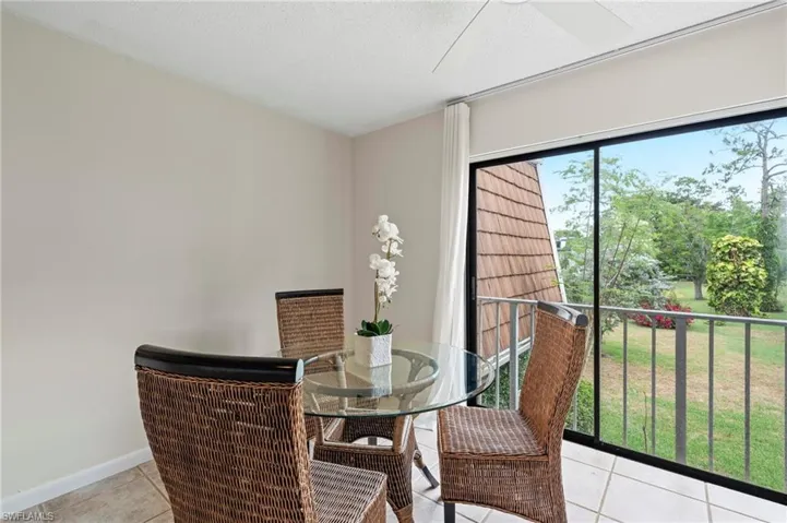 Dining area featuring light tile patterned floors and baseboards