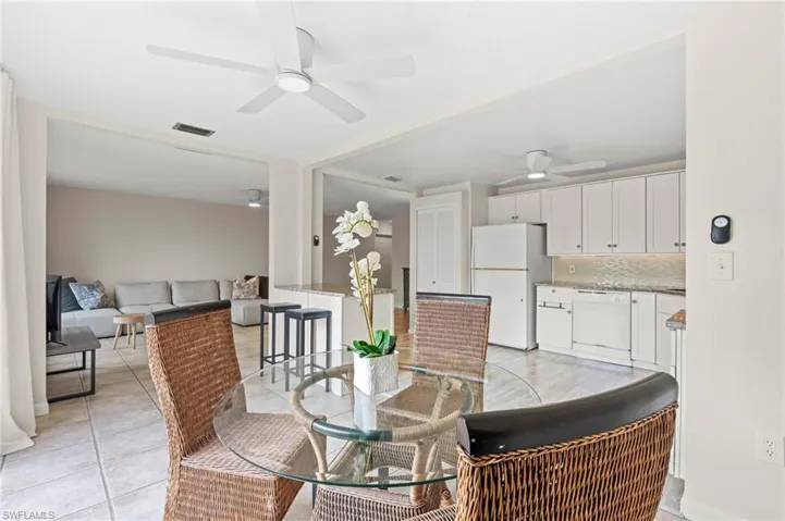 Dining room with a ceiling fan and light tile patterned flooring