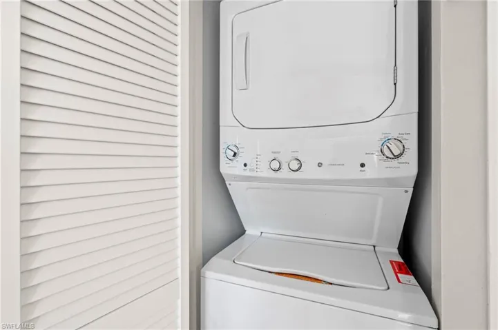 Washroom with stacked washer and clothes dryer