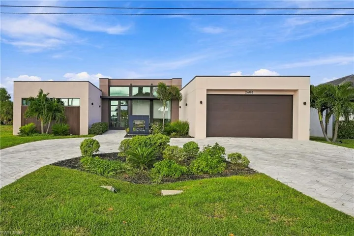 GRAND SENSE OF ARRIVAL: Modern single-story architecturally distinctive home featuring a smooth stucco finish, expansive marble- paver circular driveway, integrated two-car garage, clerestory windows