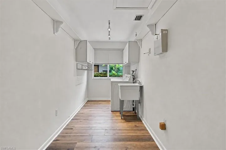 Large laudry area with wall cabinets for storage