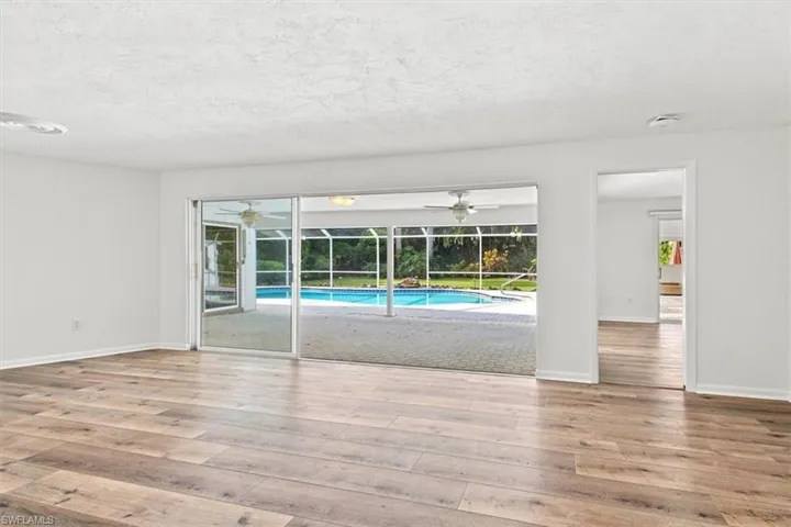 Large living room with sliders out to pool area