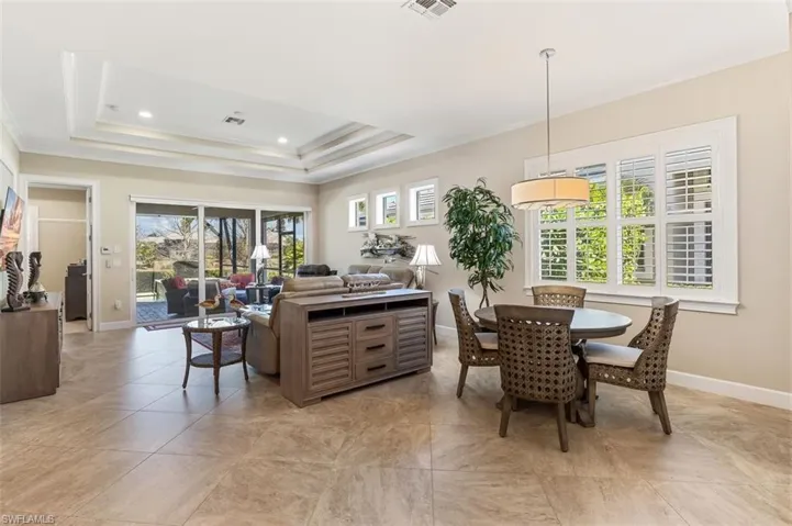 Dining area featuring crown molding, a tray ceiling, and recessed lighting