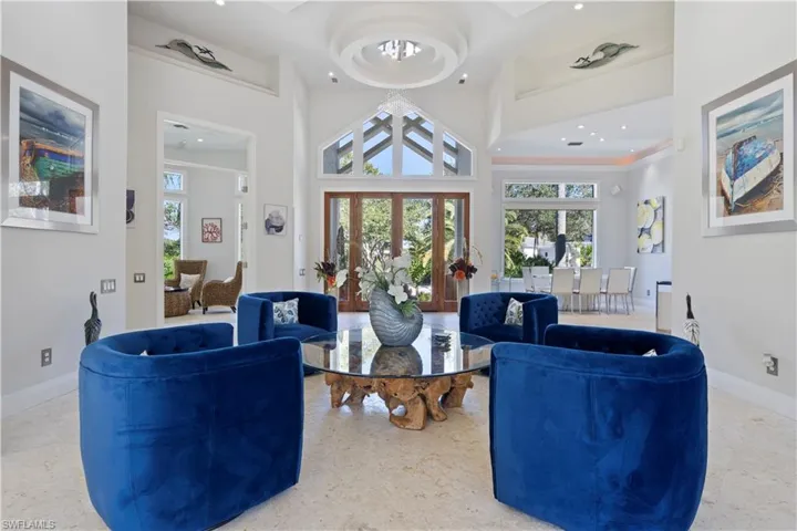 Living area featuring a towering ceiling and a chandelier