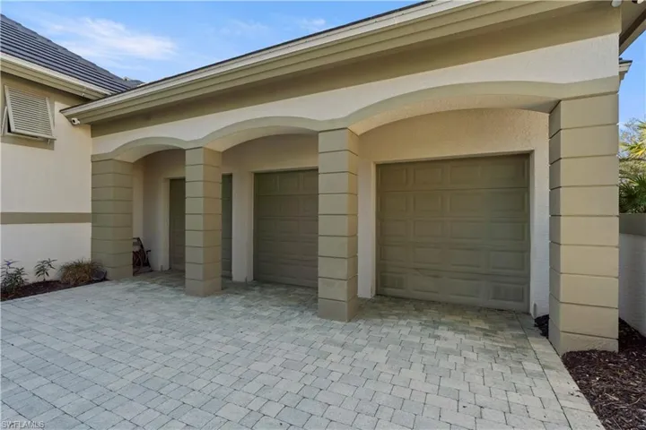 Garage featuring decorative driveway
