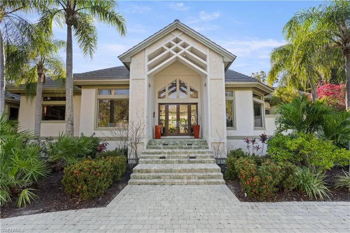Property entrance with french doors and stucco siding