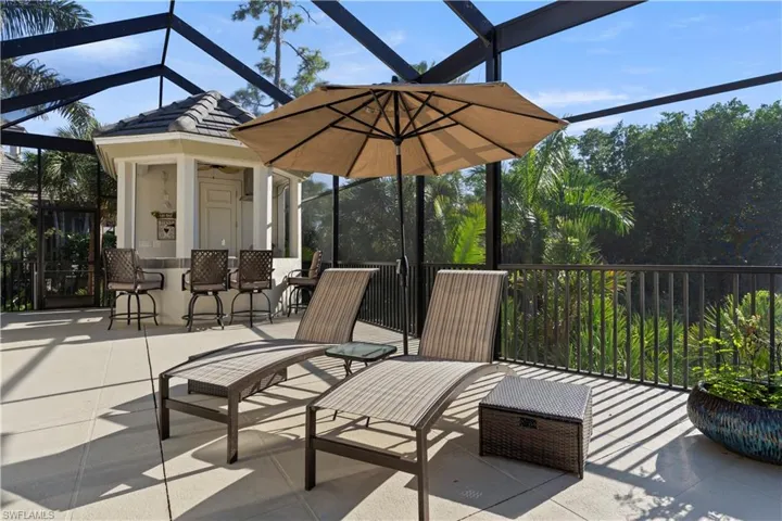 View of patio with glass enclosure and a sunroom