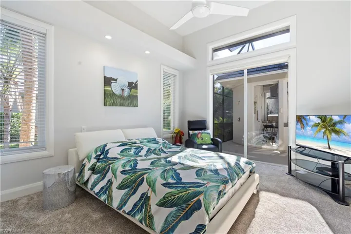 Bedroom featuring carpet flooring, access to outside, recessed lighting, and a sunroom