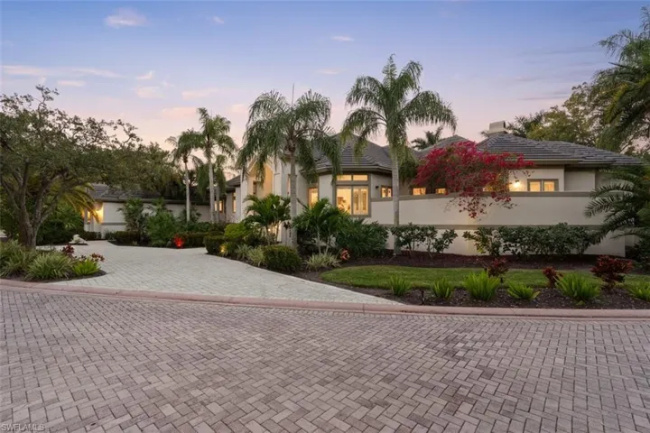View of front of house featuring stucco siding and decorative driveway