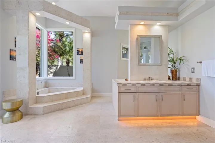 Bathroom with vanity and a bath