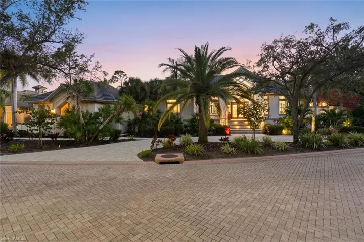 View of front of home featuring decorative driveway and stucco siding