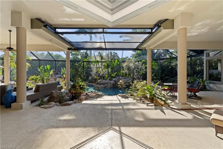 View of patio / terrace with a sunroom, glass enclosure, and a swimming pool