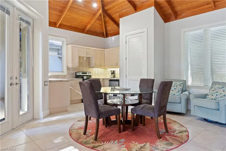 Dining area featuring wood ceiling, light tile patterned floors, and french doors