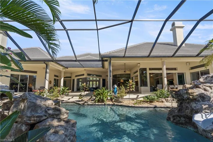 Outdoor pool featuring a sunroom, a lanai, and a patio area
