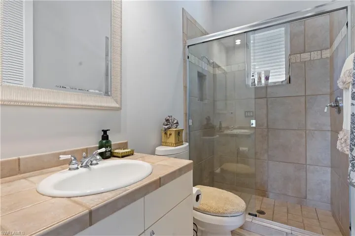 Full bathroom with vanity and a stall shower