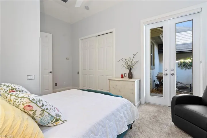 Bedroom featuring french doors, access to outside, carpet flooring, and a closet