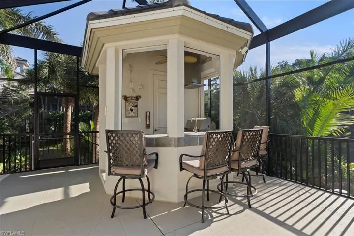 View of patio featuring a lanai, a sunroom, and a ceiling fan