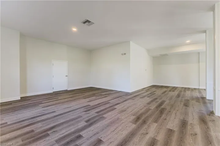 Spare room with light wood finished floors and recessed lighting