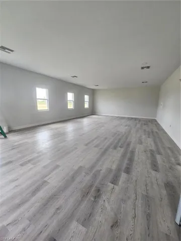 Unfurnished room with light hardwood / wood-style floors