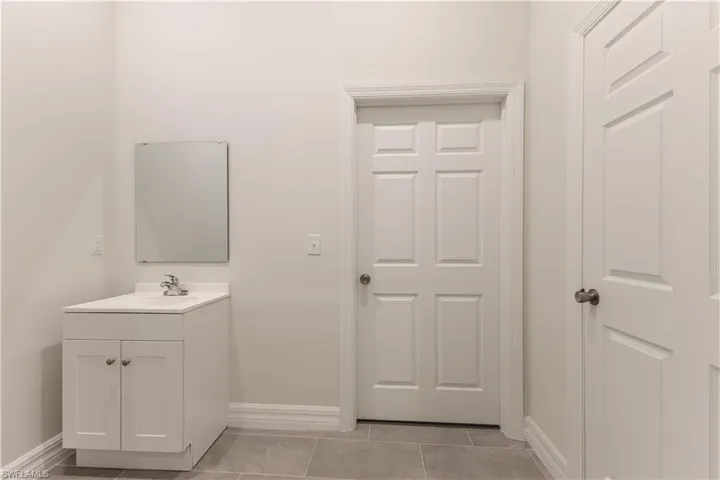 Bathroom with vanity and light tile patterned floors