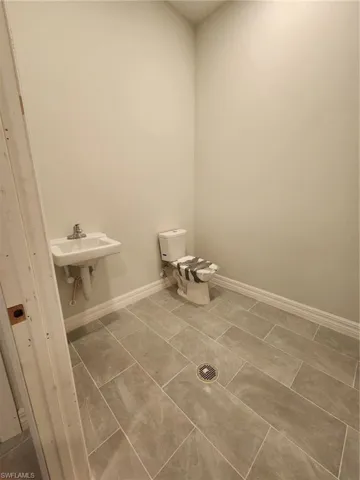 Bathroom with toilet and tile floors