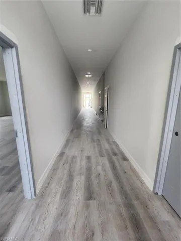 Hallway with light hardwood / wood-style floors