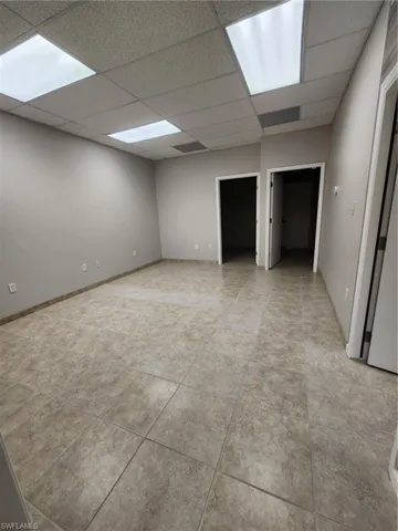 Tiled spare room with a drop ceiling