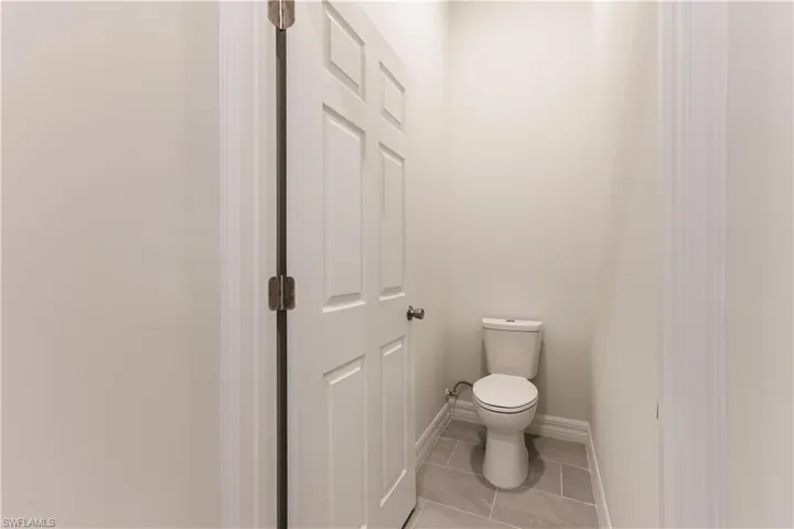 Bathroom featuring light tile patterned floors and baseboards